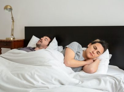 wife can't sleep because husband is snoring in bed
