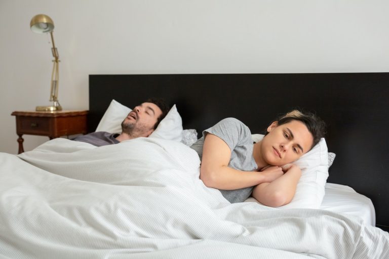 wife can't sleep because husband is snoring in bed